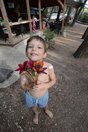 A child holding colorful flowers outdoors