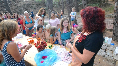 A group of people gathered around a table for an outdoor activity