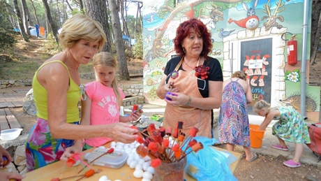 People participating in a craft activity outdoors
