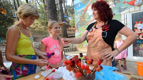 Three people participating in an outdoor craft activity
