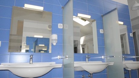 Row of sinks with mirrors in a bathroom