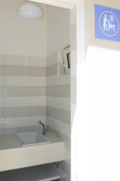 A baby changing station with a sink