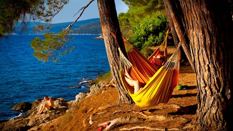 People relaxing in hammocks by the sea on Cres