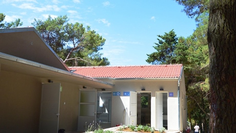A building with a red roof surrounded by trees