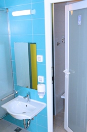A bathroom with blue tiles and a white sink