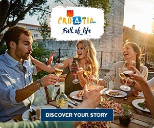 People enjoying a meal and drinks at an outdoor restaurant with a Croatia tourism logo